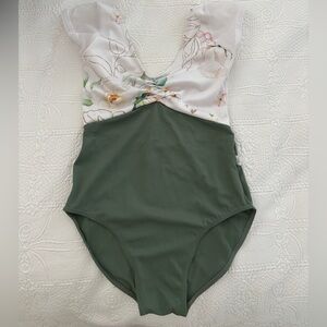 White and floral top with sage green bottom class in leotard